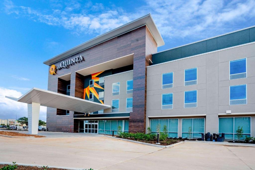 凯蒂La Quinta Inn & Suites Katy-Mills by Wyndham Katy的一座建筑的 ⁇ 染,有 ⁇ 石总部