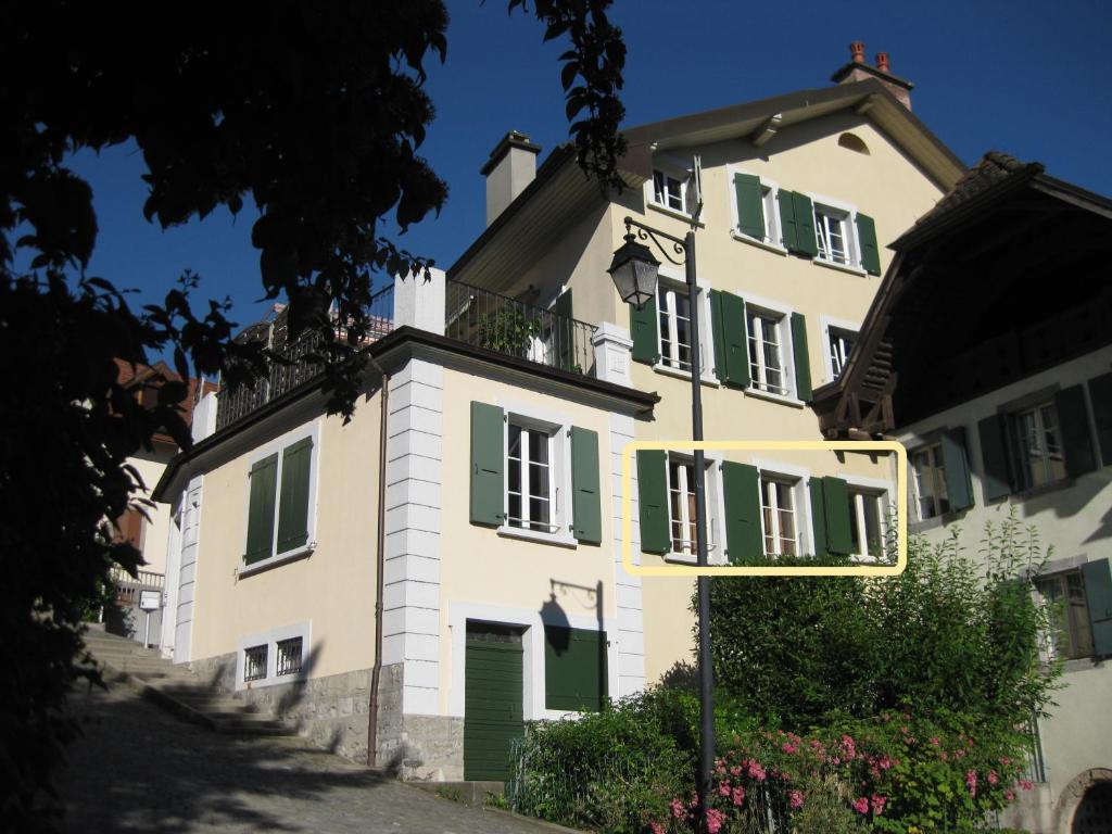 蒙特勒Apartment Montreux center 5 min from the lake的一座白色的大建筑,设有绿色百叶窗