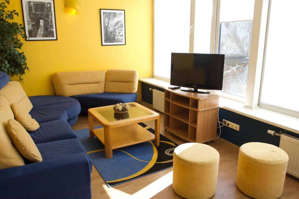 考纳斯Laisvės 50D的客厅配有蓝色的沙发和电视