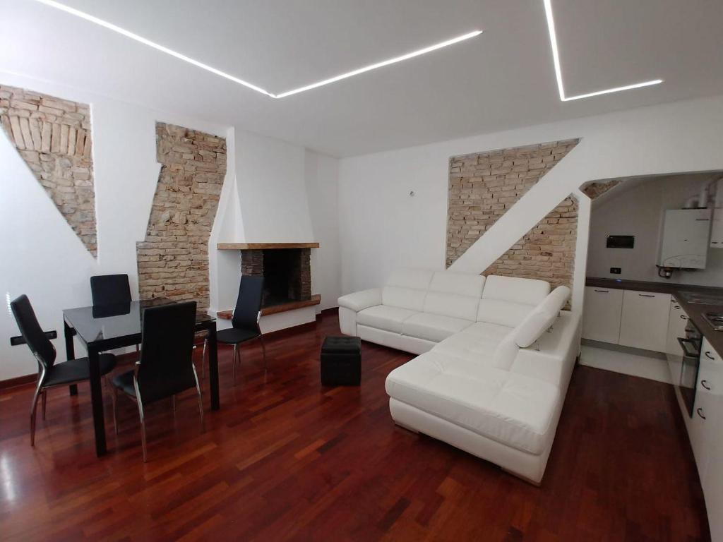 代森扎诺-德尔加达APPARTAMENTO LAKE GARDA ibiscus di Francia的客厅配有白色的沙发和桌子