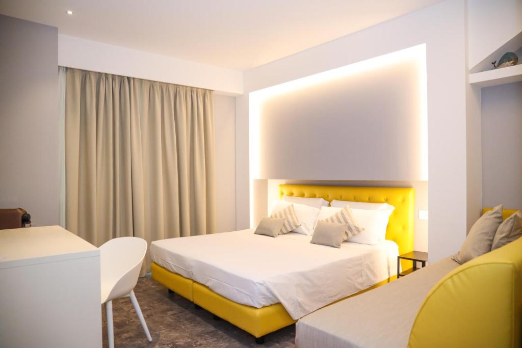 特罗佩阿J Luxury Home的配有一张床和一张书桌的酒店客房