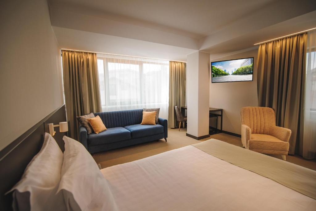 拉姆尼库沃尔恰NOVO Boutique的酒店客房,配有床和沙发