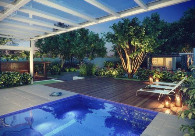 坎皮纳斯Dot Home Guanabara - Lindo Apartamento Mobiliado em Campinas的后院设有游泳池和带甲板的庭院