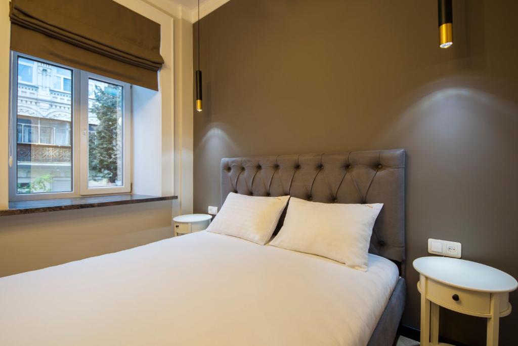 基辅Idea Design Apart-Hotel Maidan的卧室设有一张白色大床和一扇窗户。