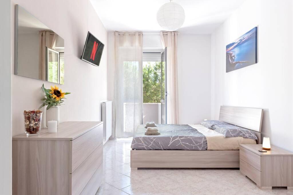 利沃诺[FREE PARKING] Appartamento 5 STELLE elegante con suite的白色的卧室设有床和窗户
