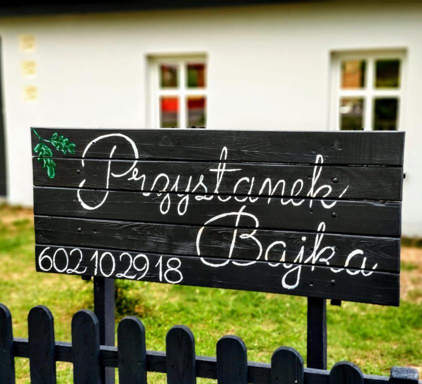 Dąbrówka KościelnaPrzystanek Bajka w Puszczy Zielonce的房屋前的标志