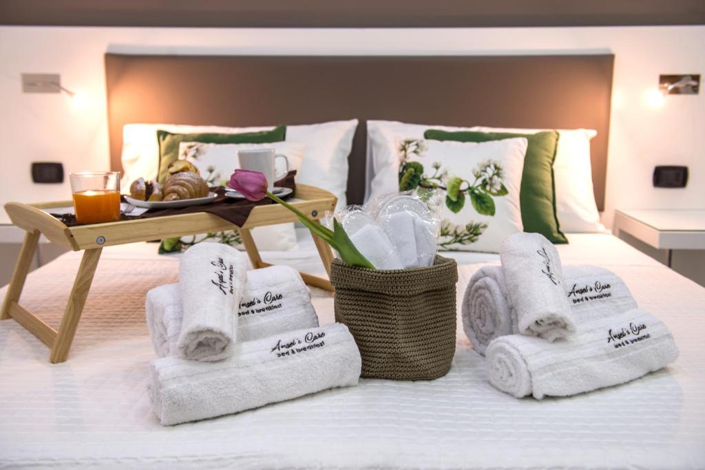 雷焦卡拉布里亚Angel's Care B&B的酒店客房的床铺上备有毛巾
