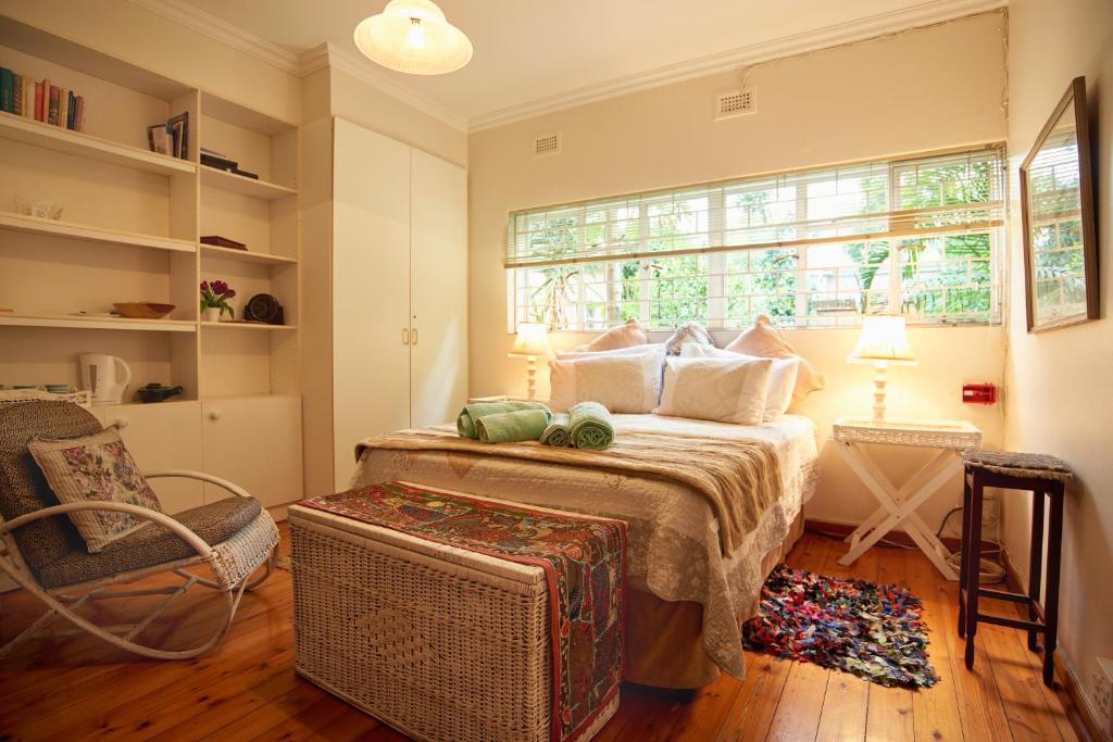 比勒陀利亚800@Merton的一间卧室配有一张带窗户和椅子的床
