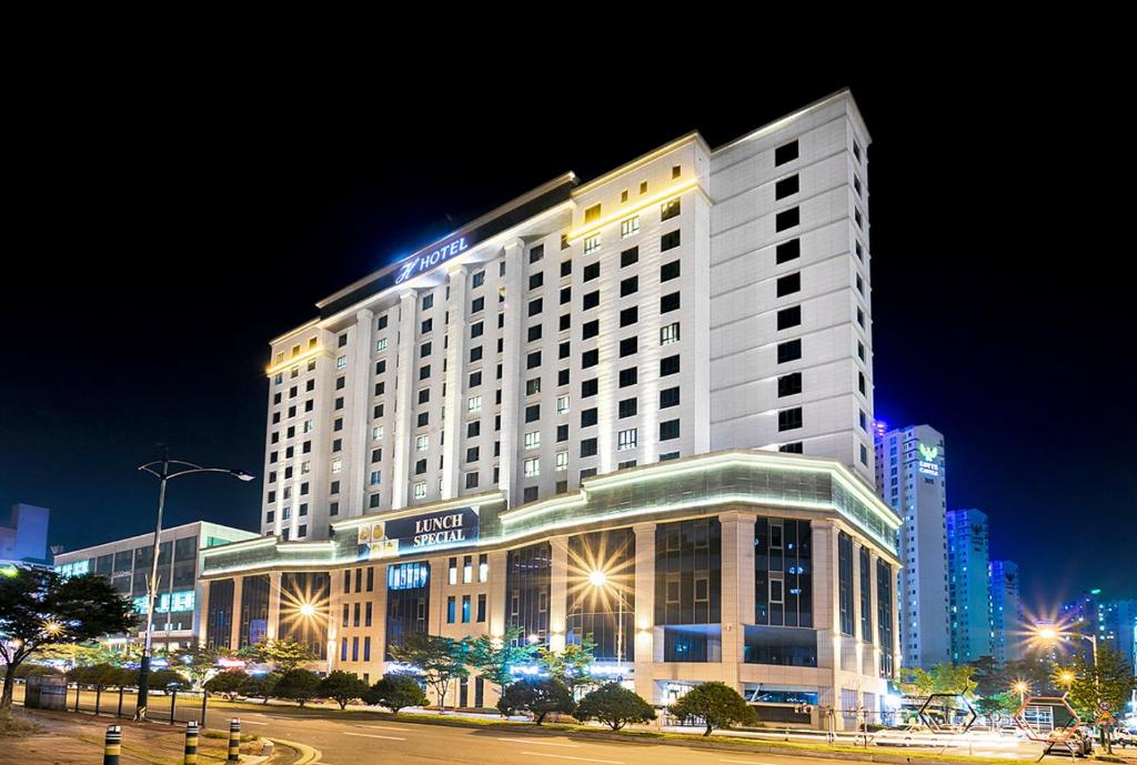 清州市Osong H Hotel Sejong City的夜间酒店大楼有照明