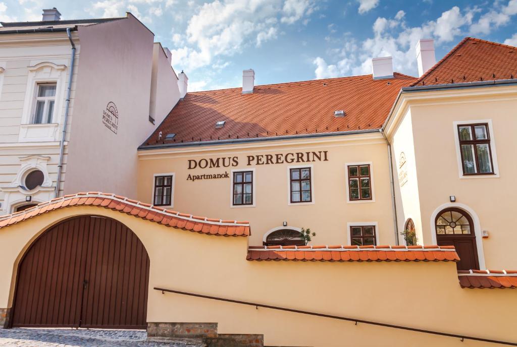 杰尔Domus Peregrini Apartmanok的带有读书的标志的建筑物