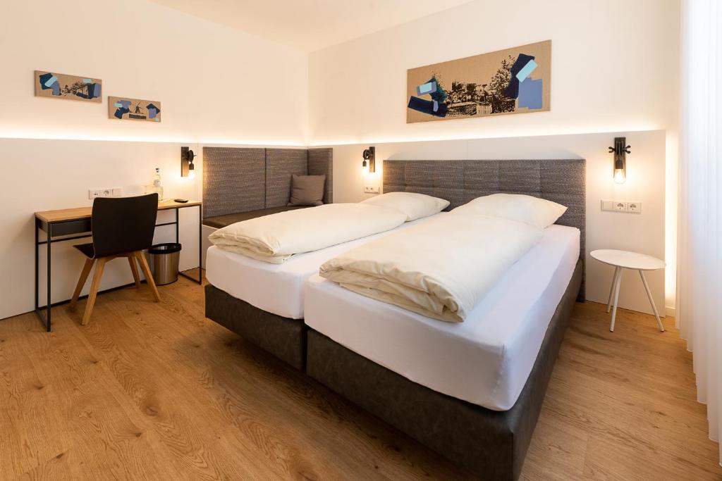 SüdlohnHotel & Gasthaus Nagel的酒店客房配有两张床和一张书桌