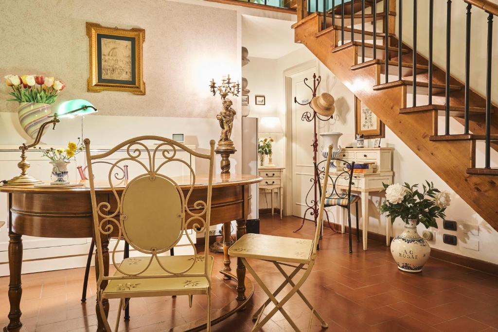 佛罗伦萨乐坎德拉邱比酒店的配有桌椅和楼梯的房间