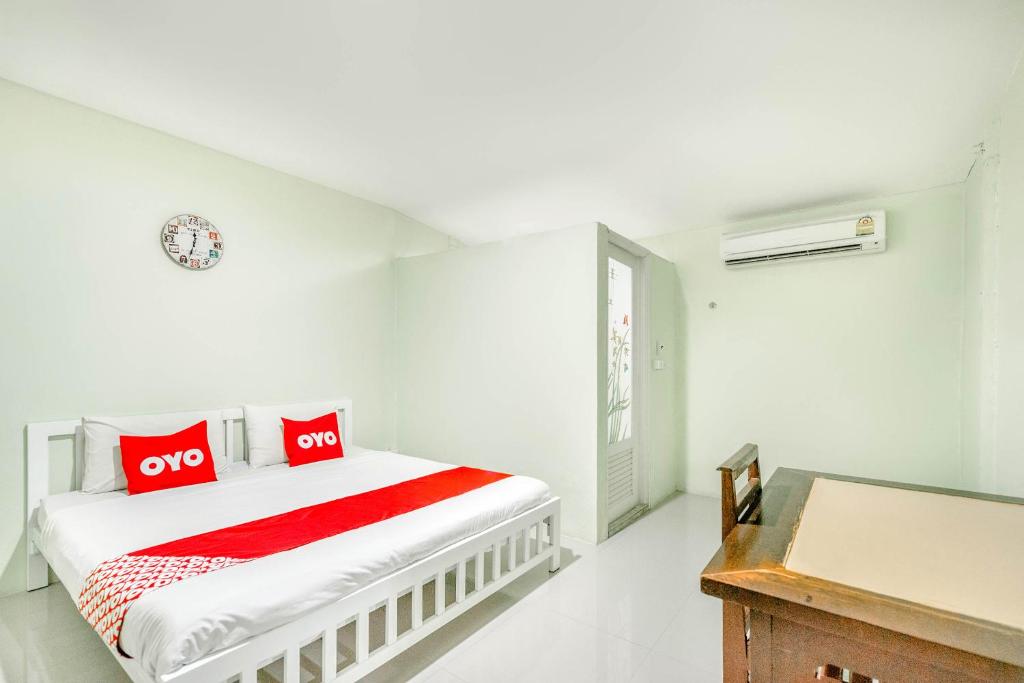 坤西育府OYO 722 I Oun Inn的白色卧室配有红色枕头的床