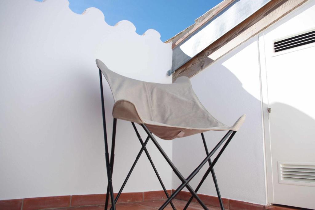 纳瓦拉Can Girmas Casa de Turisme rural Navata的墙上的折叠椅