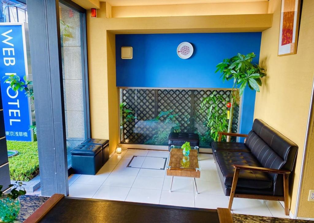东京东京浅草桥网络酒店的带沙发和蓝色墙壁的客厅