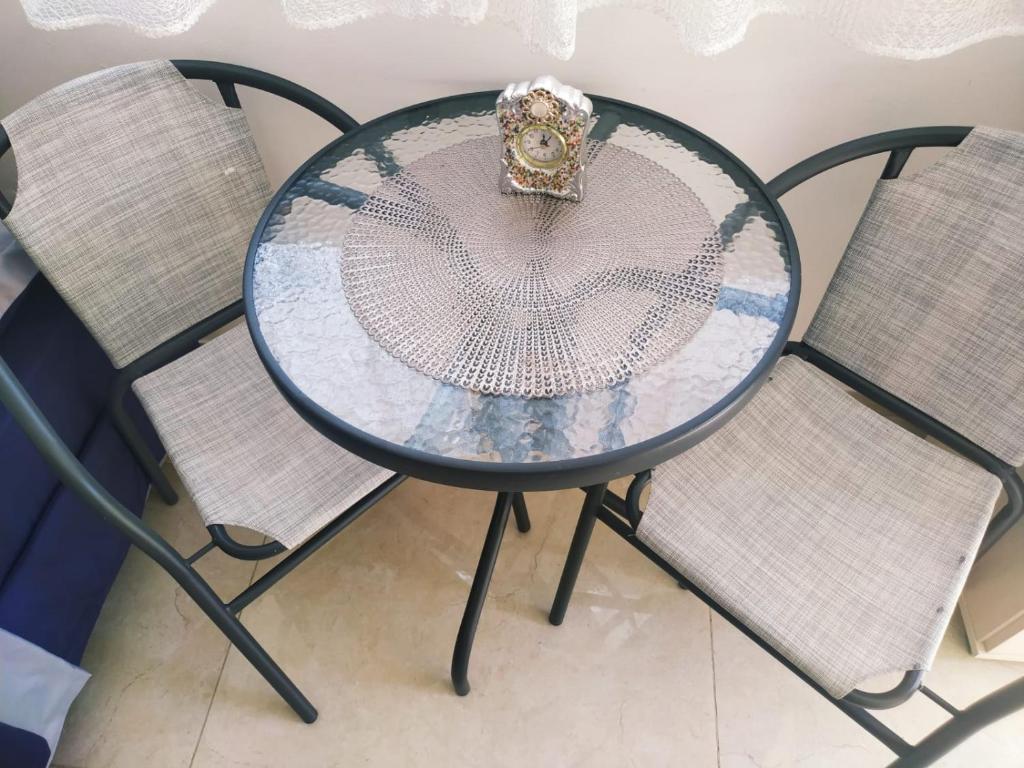Beʼer OraQuiet place的玻璃桌,两把椅子上有一个冠