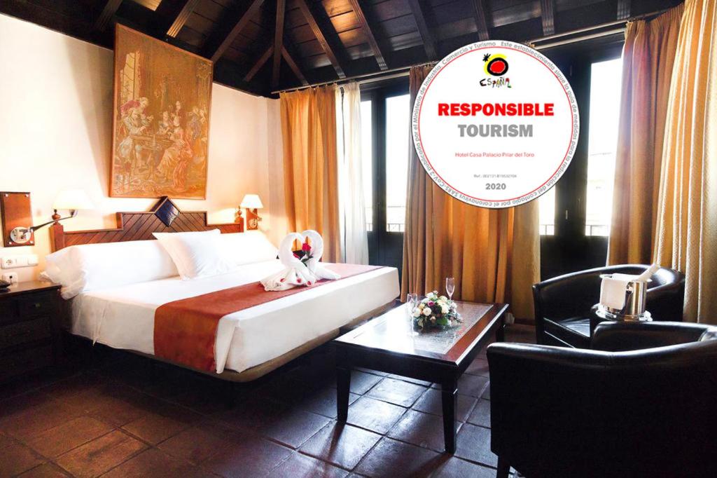 格拉纳达卡萨帕拉西奥皮拉尔·德尔·托罗酒店的酒店客房,配有一张床和一个读出共振旅游的标志
