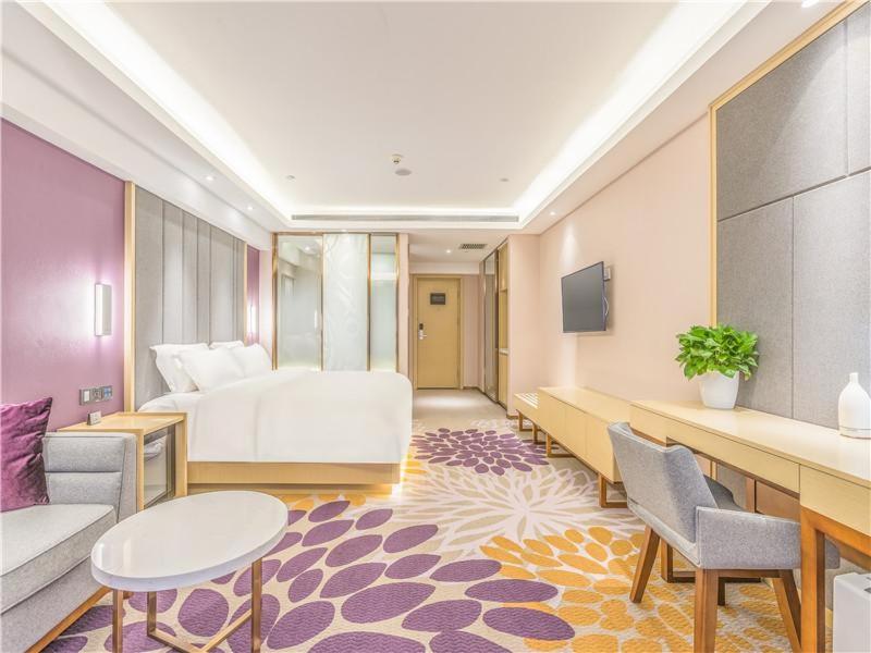 大城县Lavande Hotel Langfang Dacheng Xinda Xintiandi Plaza的酒店客房带一张床、一张桌子和椅子