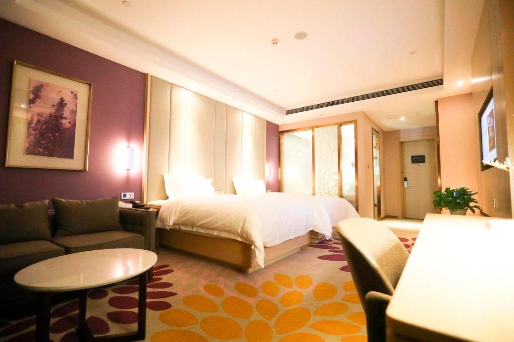 石家庄Lavande Hotel (Shijiazhuang Luquan Baoduzhai Beiguo Shopping Center Branch)的酒店客房,配有床和沙发