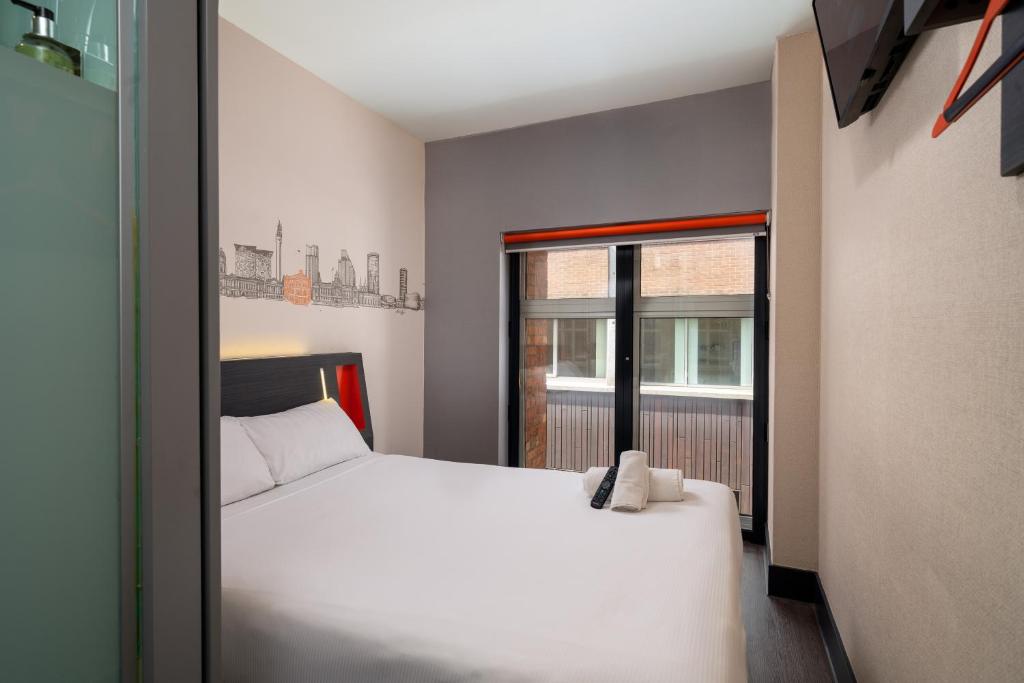 伯明翰伯明翰休闲酒店的卧室配有白色的床和窗户。