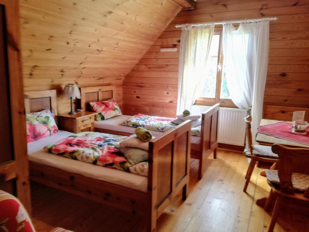 TrahüttenDa Tizzi的小木屋内一间卧室,配有两张床