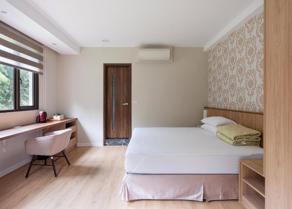 名竹旅社 Minzu Hotel客房内的一张或多张床位