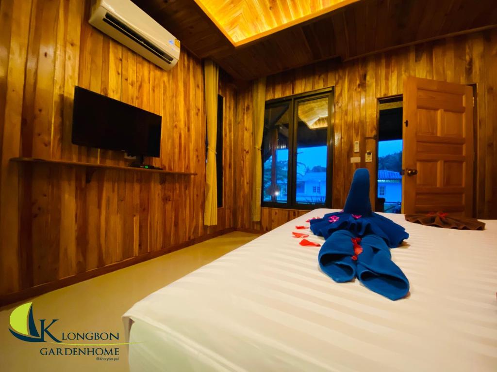 瑶亚岛KLONGBON GARDEN HOME Koh Yao Yai的一间卧室配有一张蓝色弓床