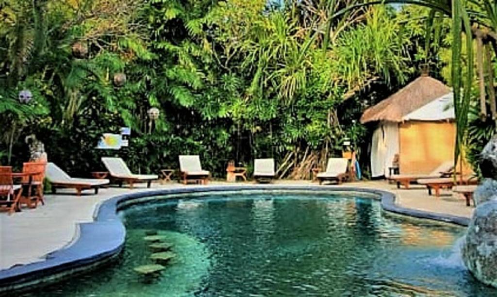 塞米亚克普瑞岑达纳度假酒店巴厘岛的度假酒店内带桌椅的游泳池