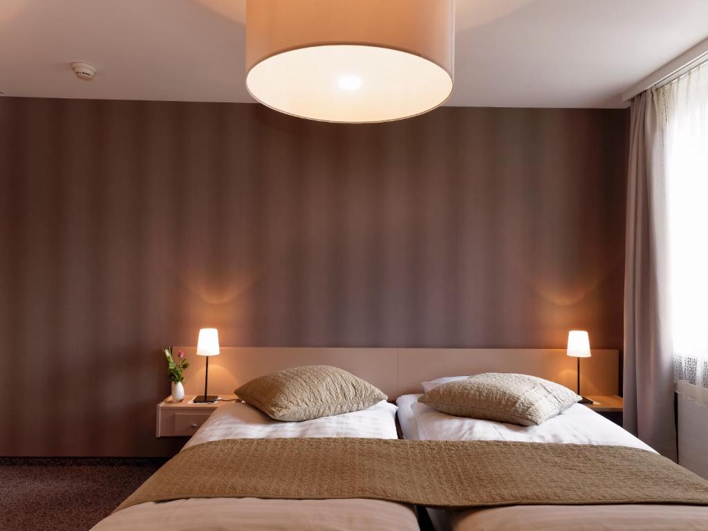 帕耶讷套房酒店的一间卧室设有两张床和大窗户
