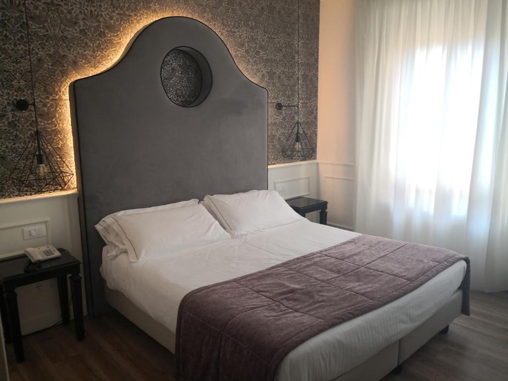 维罗纳圣卢卡酒店的一间卧室设有一张大床和一个窗户。