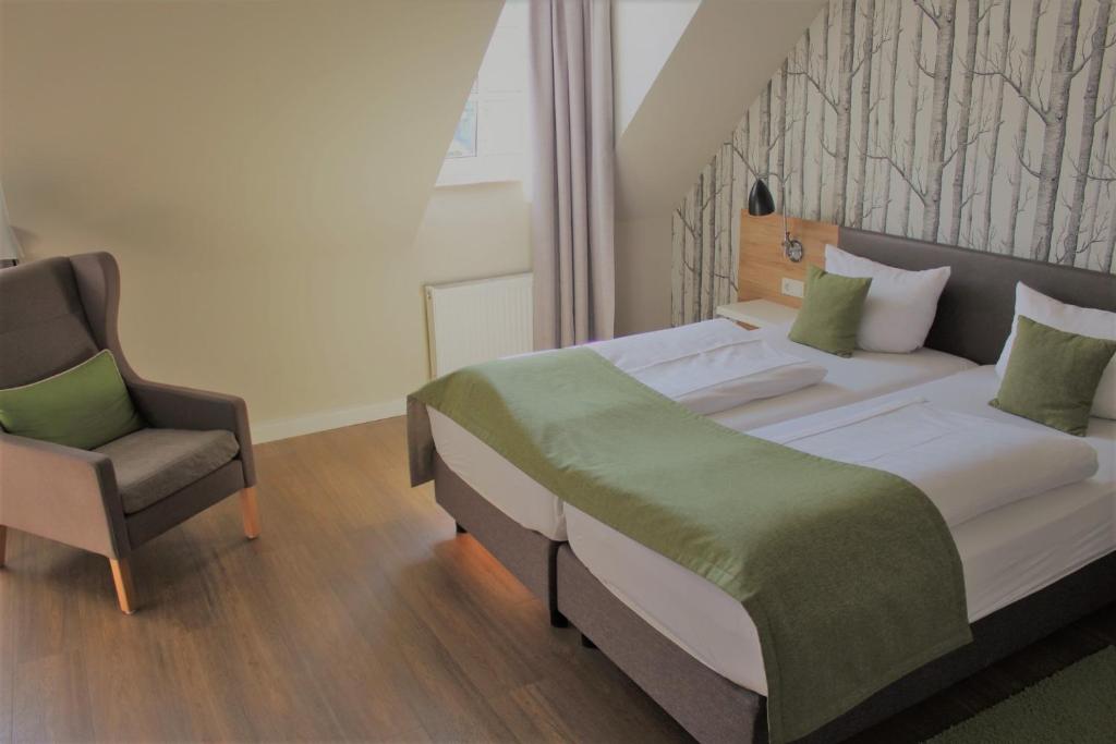 比特堡埃菲尔布劳酒店的一间卧室配有一张床和一把椅子