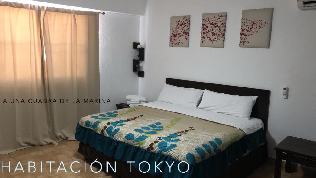 卡波圣卢卡斯Cabo Tortuga Hotel Boutique的一间卧室配有床,床上装有被子