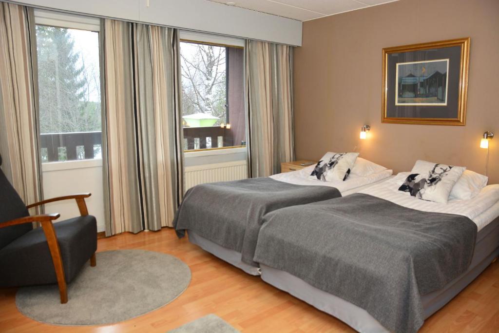 HankasalmiRevontuli Resort Rooms的酒店客房,配有两张床和椅子
