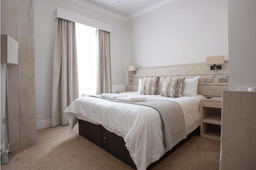 约克The Vanguard York - Private Residence的白色的卧室设有一张大床和一个窗户
