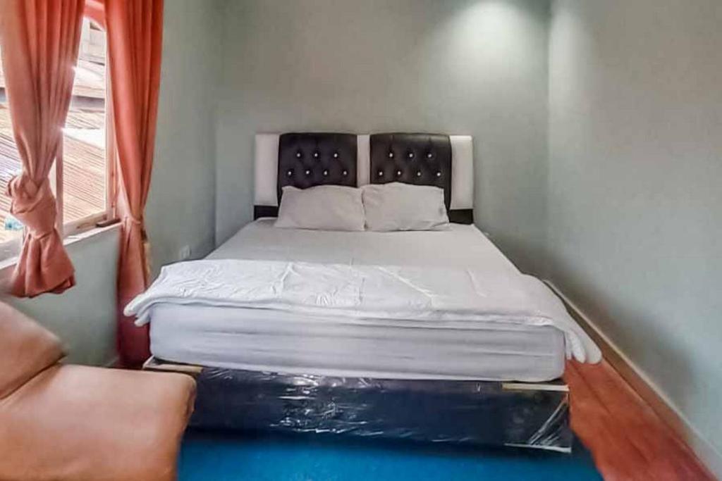 巴东Asokatama Residence Syariah Mitra RedDoorz的一个小房间的一个床位,设有窗户