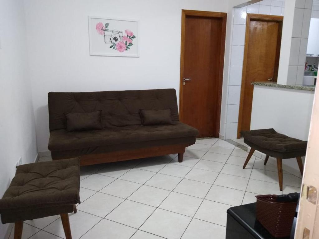 桑托斯Apto no Bairro do Gonzaga的客厅配有沙发和两把椅子
