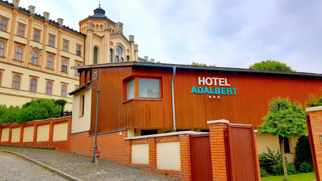 艾斯特根Hotel Adalbert Szent György Ház的红色的建筑,上面写着酒店书