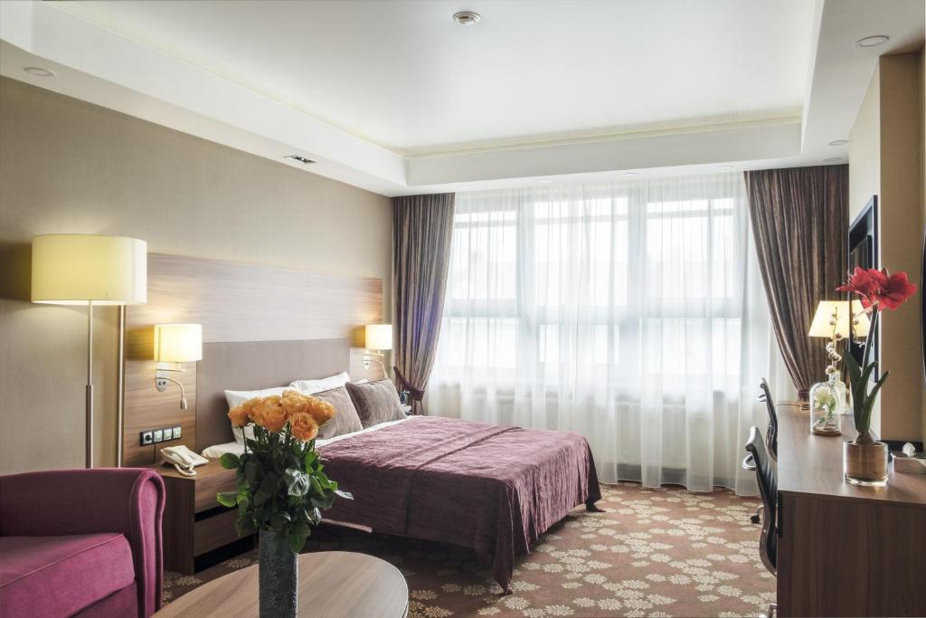 布良斯克Grand Hotel Bezhitsa的酒店客房,配有床和沙发