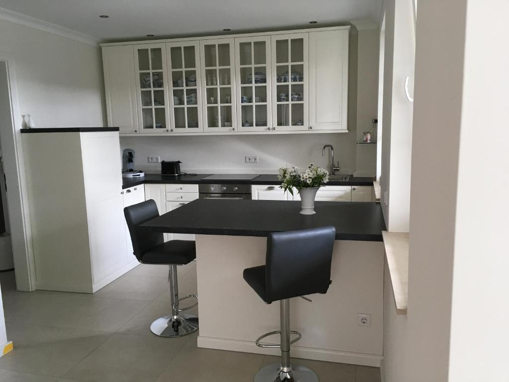 奥登塔尔Großzügiges Appartement -ruhig und doch zentral的厨房配有白色橱柜和黑色台面