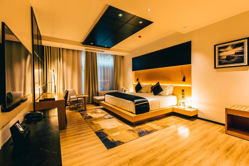 达累斯萨拉姆Blackwood Boutique Hotel and Apartments的酒店客房,配有床和电视