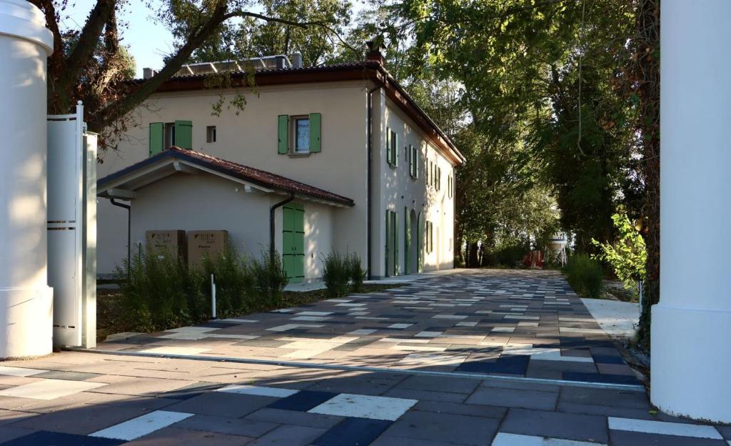 San Giorgio di PianoVilla Il Selvatico的街道上带绿门的白色建筑