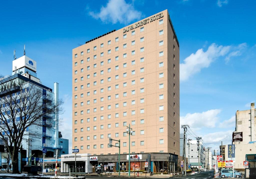 秋田大和鲁内秋田酒店的一条城市街道上高大的棕褐色建筑