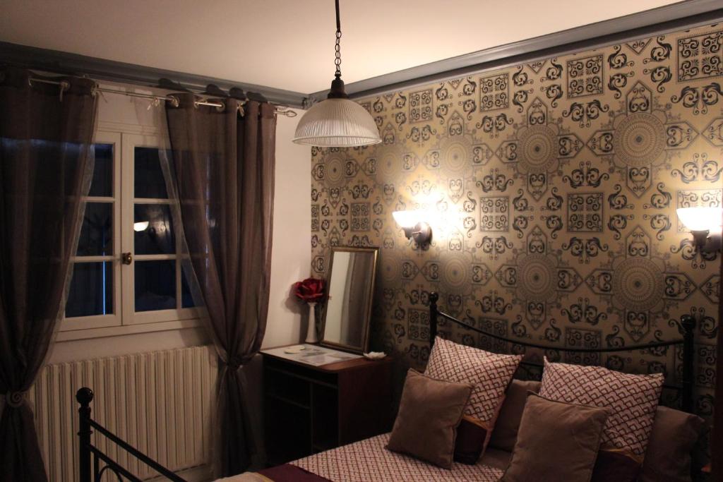 尚托奈Au Coeur du Bocage Vendéen的一间卧室设有一张床和一个窗口