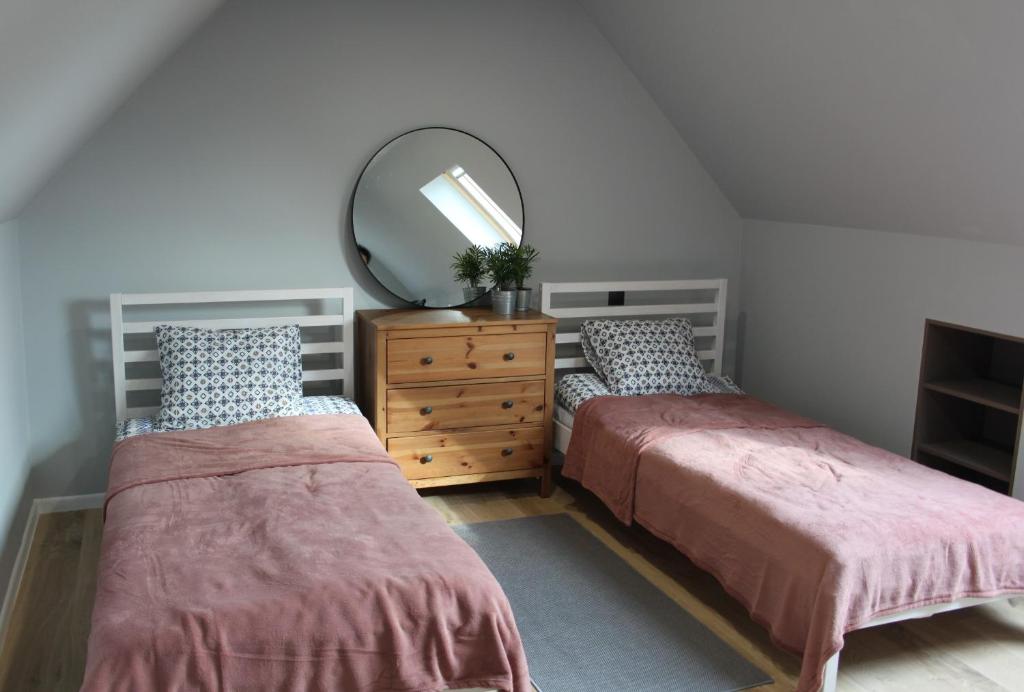 斯诺科Agroturystyka Pokoje Stajnia Lidia的一间卧室配有两张床、镜子和梳妆台