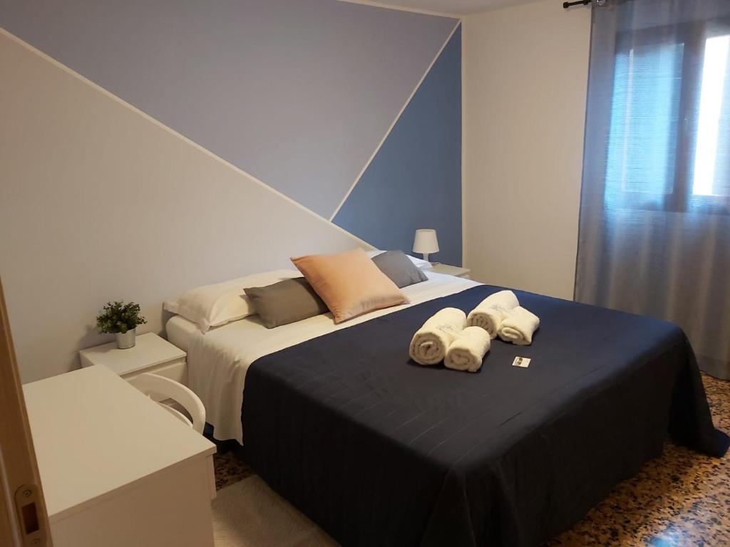 威尼斯Veneziacentopercento Apartments & Rooms的一间卧室配有一张大床和毛巾