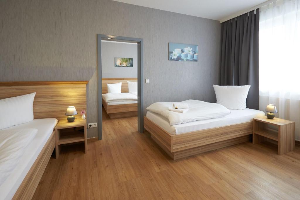 阿波尔达魏玛伯格酒店的酒店客房,设有两张床和镜子
