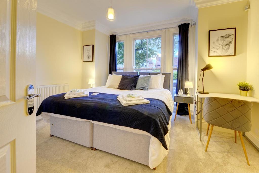 利明顿温泉Leamington Spa Warwick Place Apartments的一间卧室设有一张大床和一个窗户。