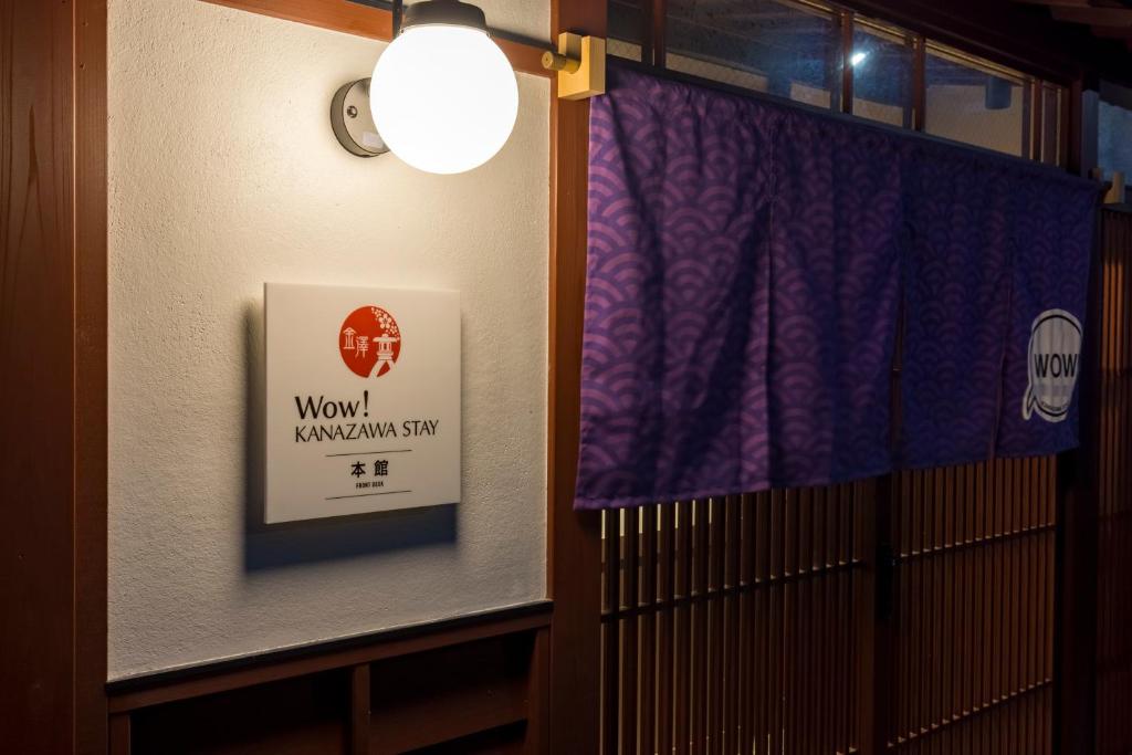 金泽Wow! KANAZAWA STAY的门上挂着标志的窗户