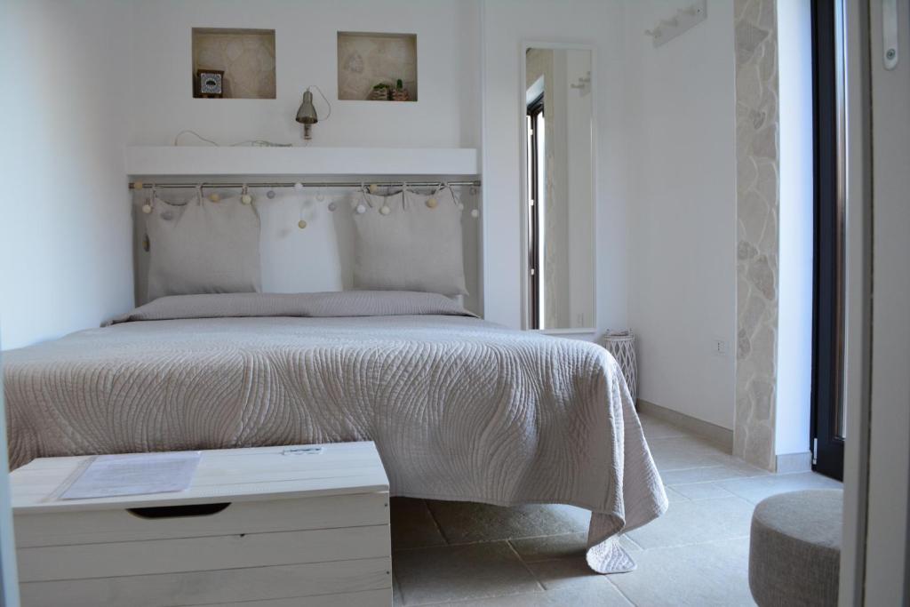 巴里Flavì的白色卧室配有一张带白色毯子的大床