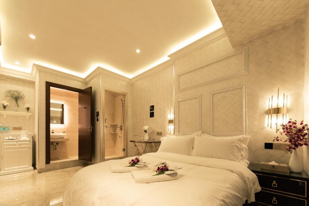 哥打京那巴鲁AJ Residence - Above Peppermint Asia City的一间带白色大床的卧室和一间浴室